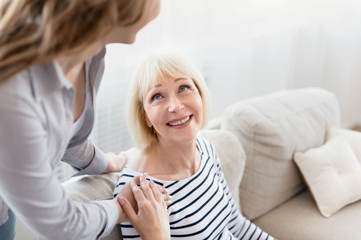 An adult daughter spending time with her mother at home