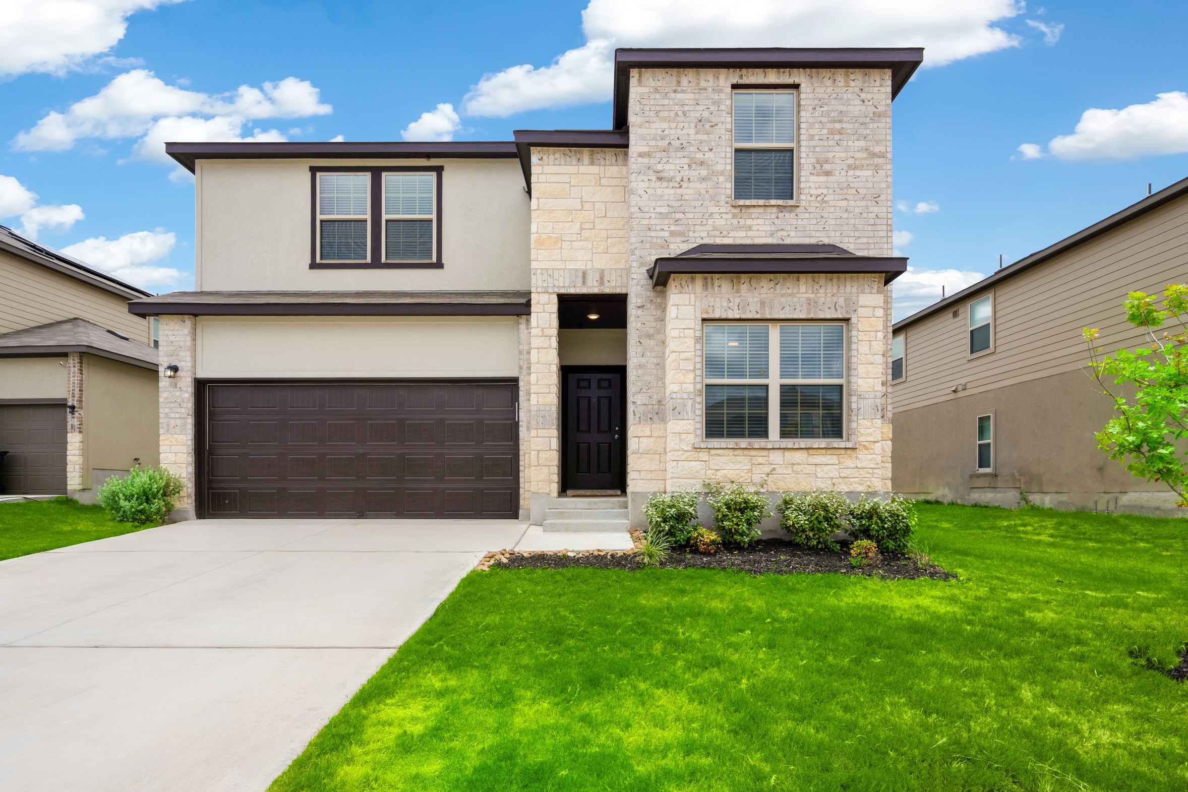 The exterior of a single-story family home with a well-kept front lawn
