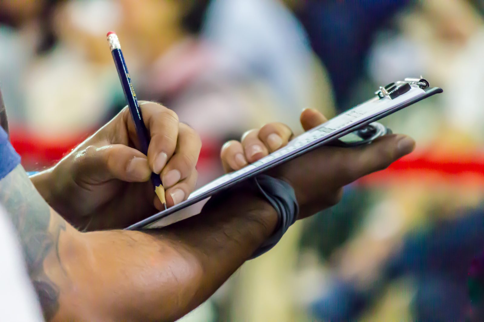 A person reviewing a checklist by hand, marking items off