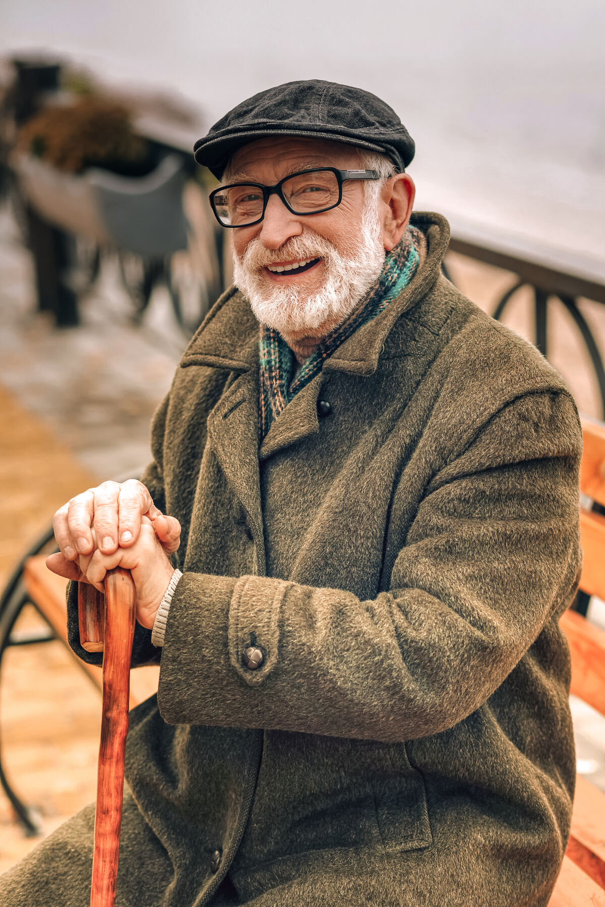 A smiling older man sitting outside on a good day