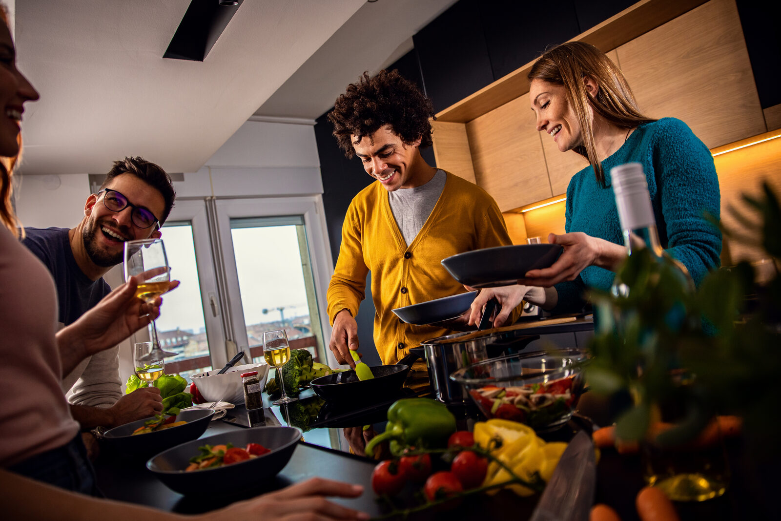 A group of people preparing a meal together in a shared kitchen