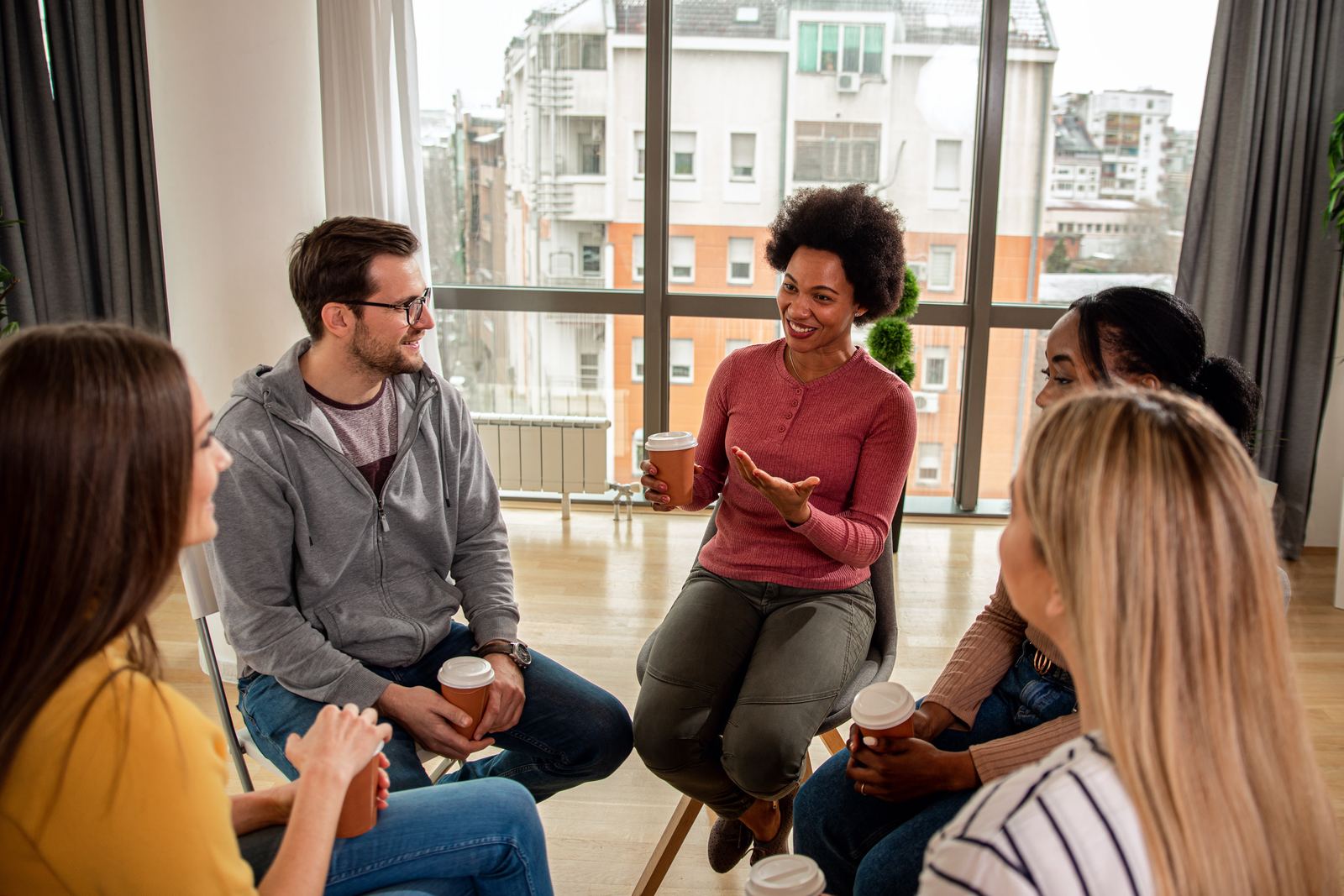 A group sitting together in conversation in a shared living room